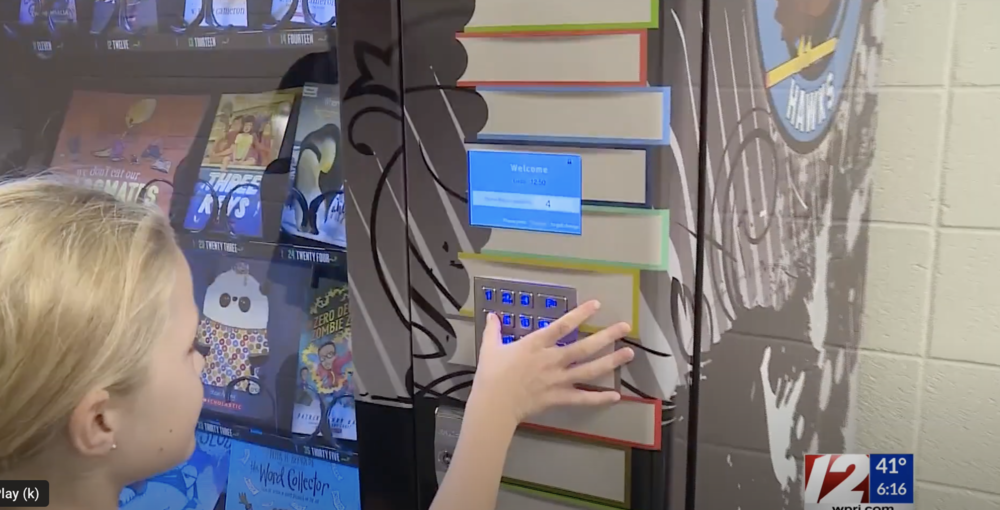 Hailey Miller chooses a book from Hoxsie School's book vending machine