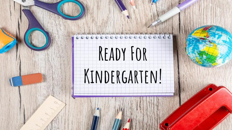 desk with schools supplies, open notebook ready for kindergarten text