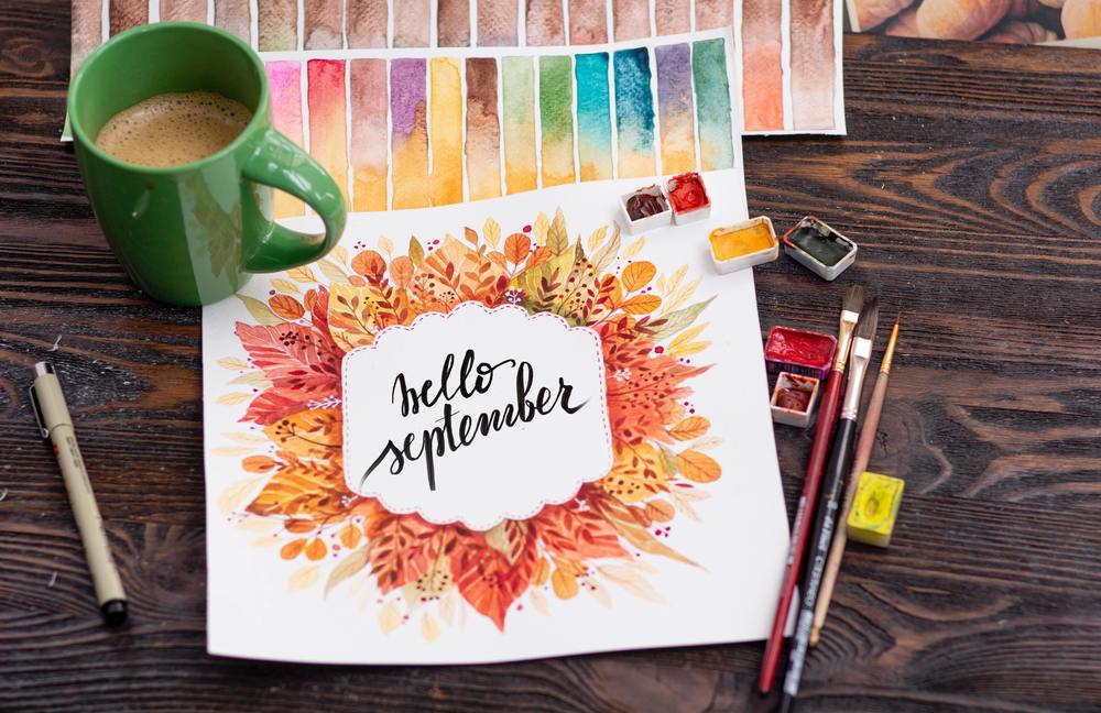 Hello September painting, paint brushes, coffee mug, paints