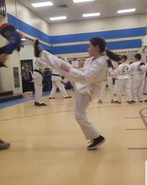 female student demonstrating kick