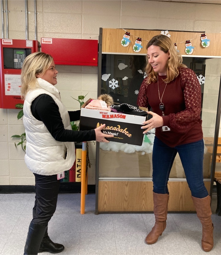 WACTC teacher donating hats and gloves to Oakland Beach School.