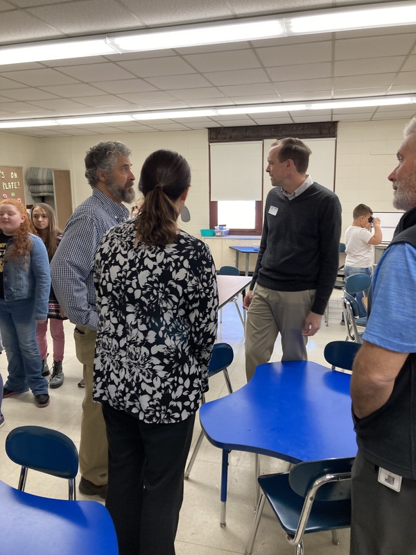 Mr. McLendon, Dr. Schultz (center, Mr. McCoombs (right) and Mr. Scotti (left) discuss this positive experience